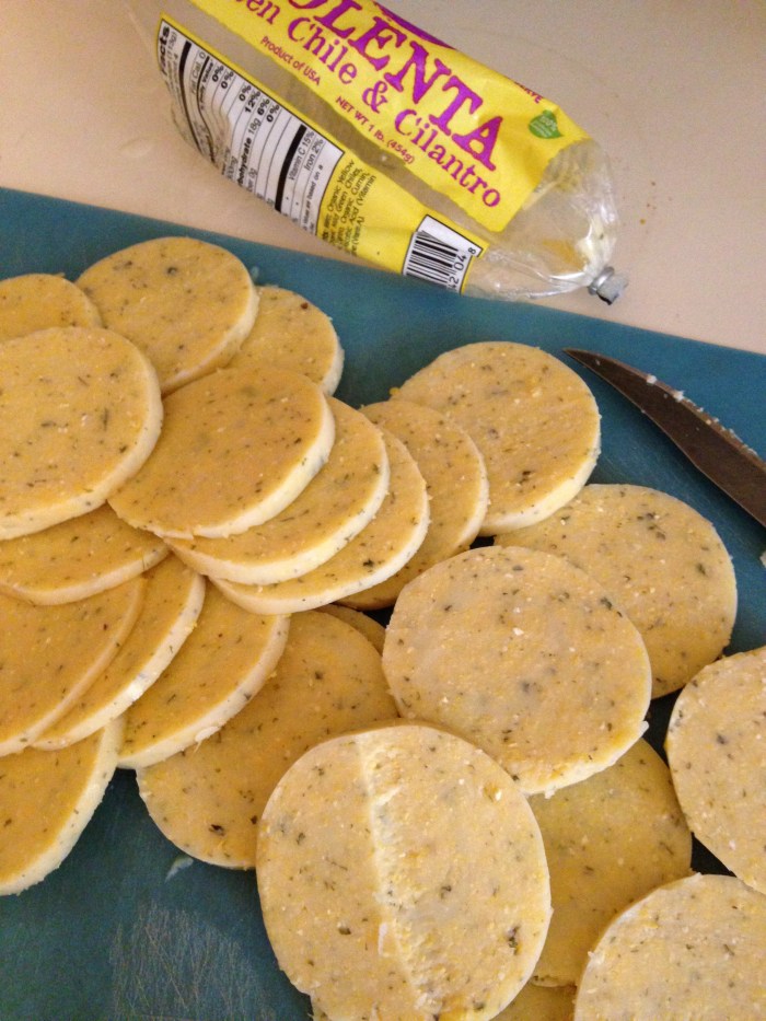 A tube of polenta cut into "Nacho"-sized rounds.